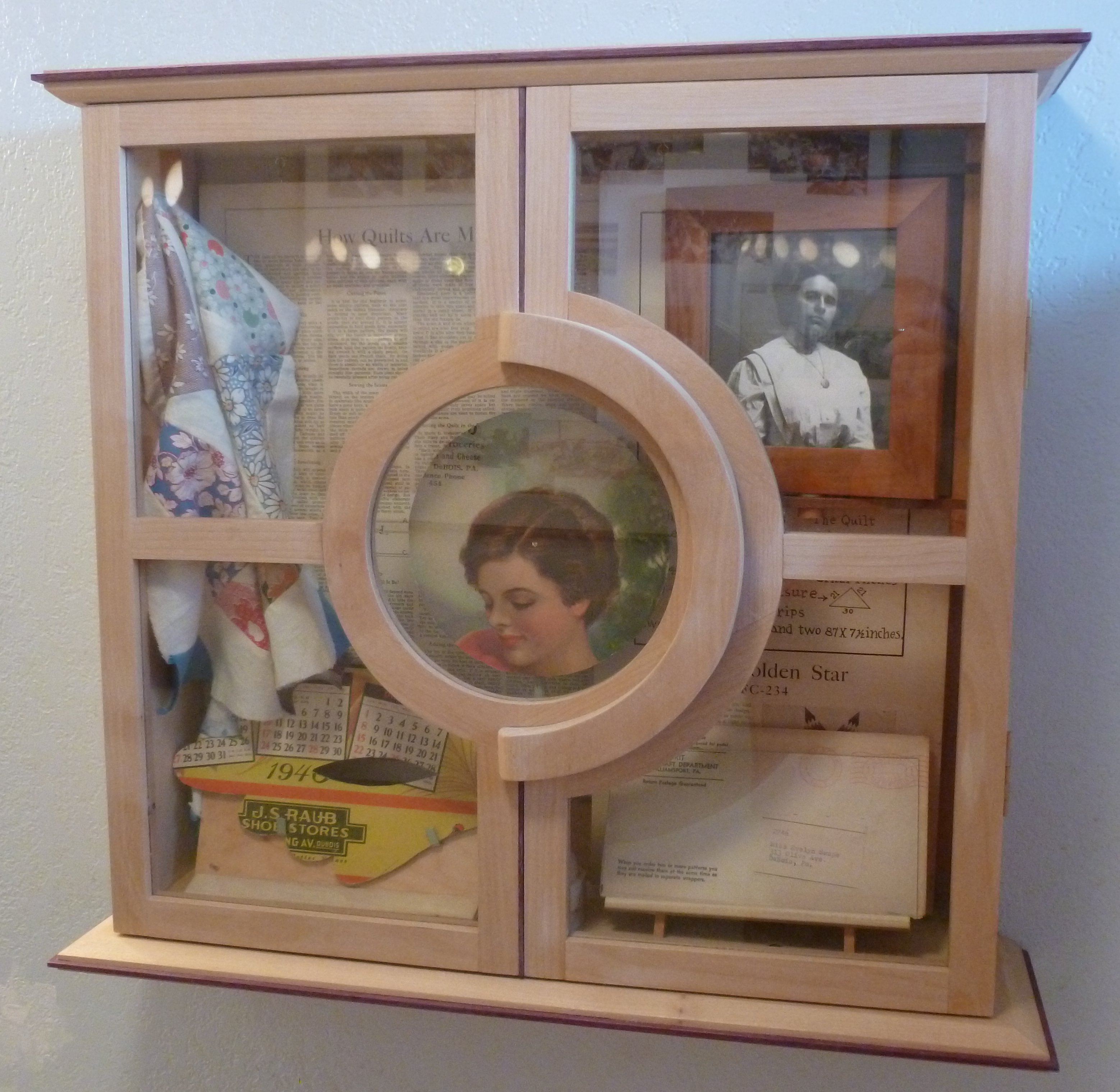 Memory cabinet with porthole window and vintage ephemera